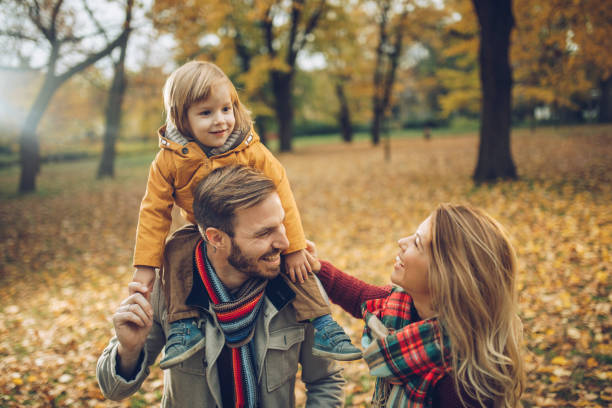 istock Young happy family talking while spending an autumn day in nature. 984747572