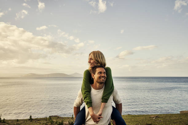 Couples that explore together adore each other Cropped shot of an attractive young couple spending the day in nature two people embracing stock pictures, royalty-free photos & images