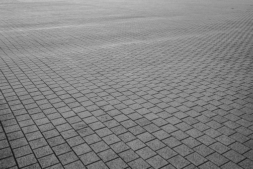 Patterned paving tiles cement brick floor background black and white