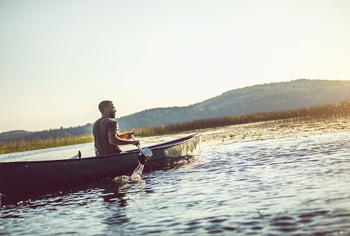 Young Woman Canoeing on the Lake