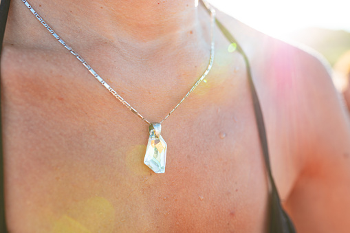 Shiny pendant on a female necklace