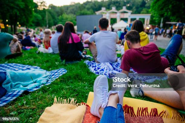 People Watching Movie In Open Air Cinema In City Park Stock Photo - Download Image Now