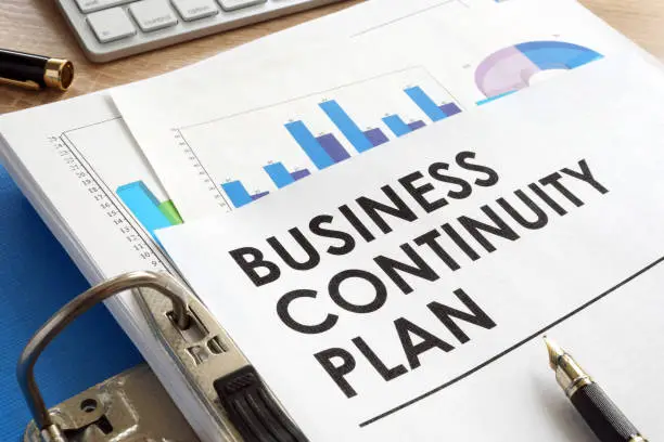 Business continuity plan in a blue folder.