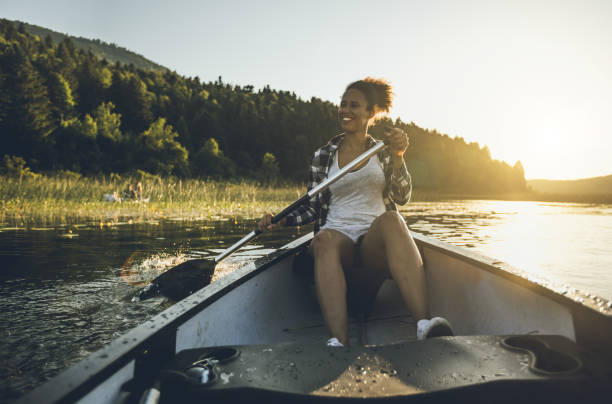 Woman canoeing at lake with dog in Finland