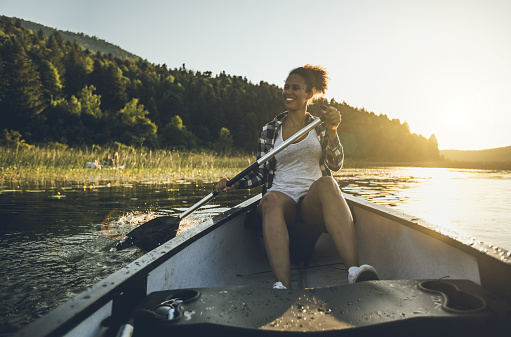 Young Woman Canoeing on the Lake