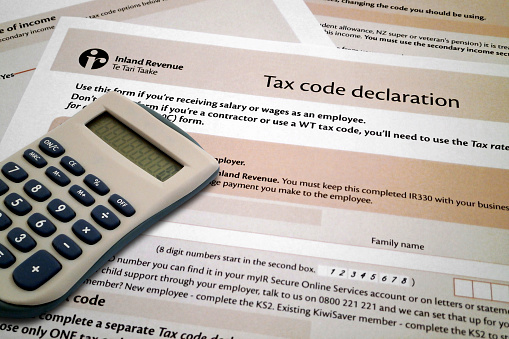 A calculator on the top of Tax code declaration form from New Zealand.