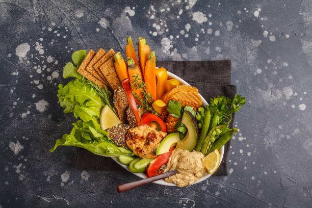 вегетарианский арабский хумус с овощами и различными закусками на темном фоне, копирует пространство, вид сверху. концепция здоровой веган - avocado lemon snack cracker стоковые фото и изображения