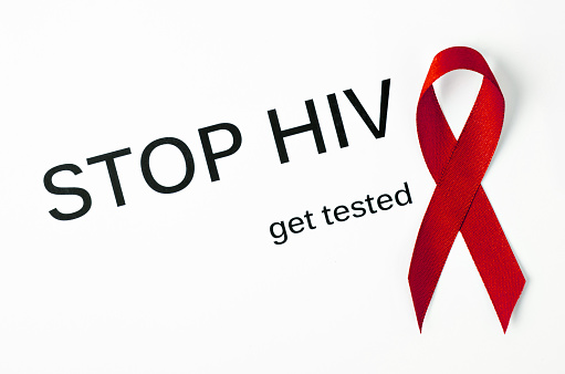Stop HIV get tested with red ribbon on white background.