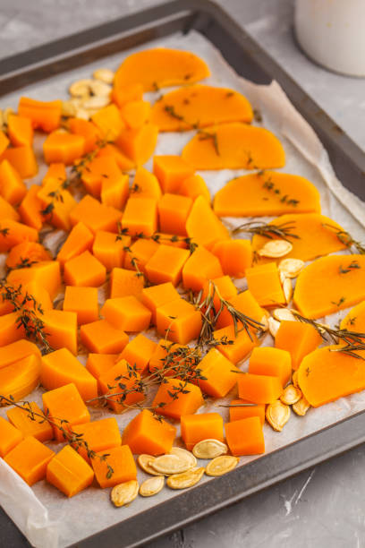 istock Pumpkin baked with herbs and garlic on a baking sheet. 984781974