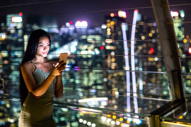 istock Beautiful young woman taking selfie at night 984782622