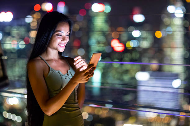 istock Beautiful young woman taking selfie at night 984782626