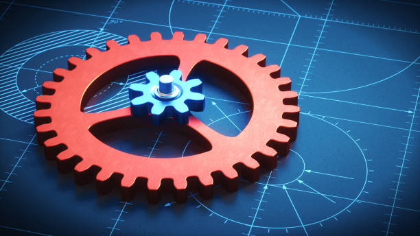 Red & blue gears on a hatching blueprint low angle view