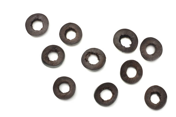istock Marinated slices black olives isolated on white background. top view 984786368