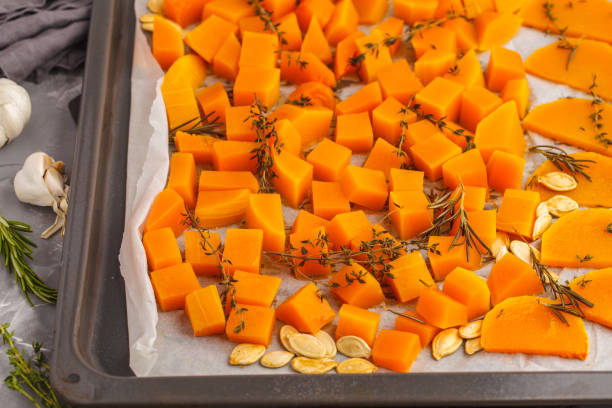 istock Pumpkin baked with herbs and garlic on a baking sheet. 984786674