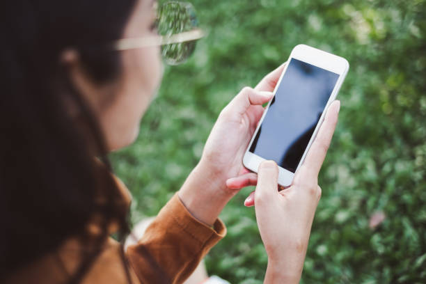 istock Hands holding / using smartphone / cell phone with isolate screen for internet online shopping and e-commerce transfer money concept 984787238