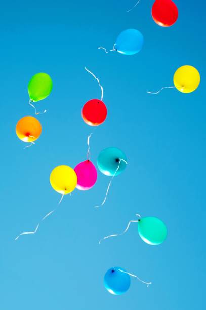 istock multicolored balloons are flying in the blue sky 984787440