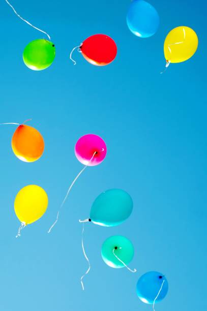 istock multicolored balloons are flying in the blue sky 984787452