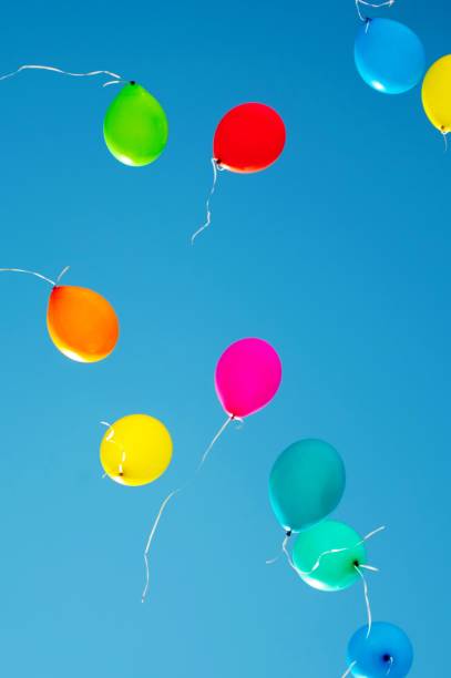 istock multicolored balloons are flying in the blue sky 984787490