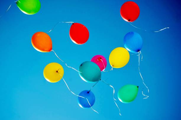 istock multicolored balloons are flying in the blue sky 984787556