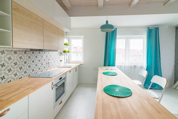 istock Open bright kitchen with white furniture. Island kitchen. 984787974