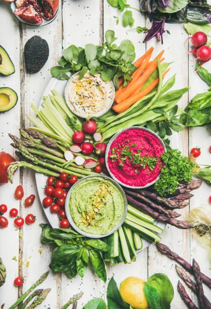 Healthy raw summer vegan snack plate over white table background