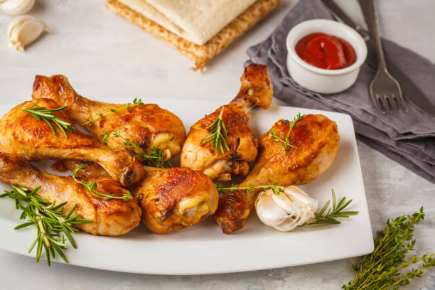 istock Grilled spicy chicken legs baked with garlic, rosemary and thyme 984792208
