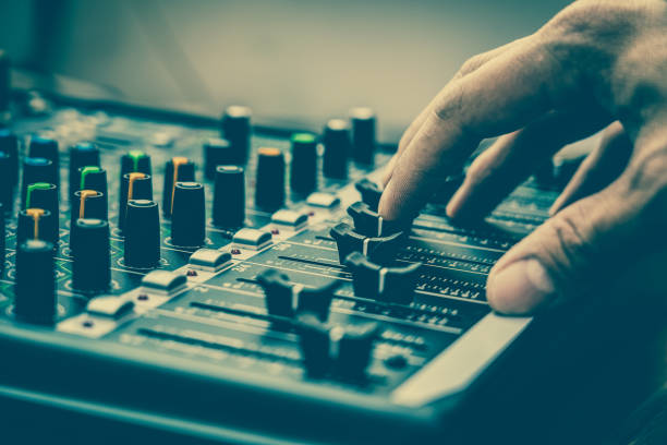 Closeup hand adjust the audio mixer, music equipment concept