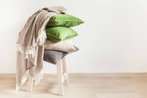 istock gray and green cushions, throw. cozy home 984802706