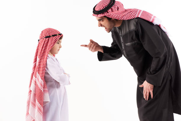 istock Arab dissatisfied father scolds son in ethnic 984803502