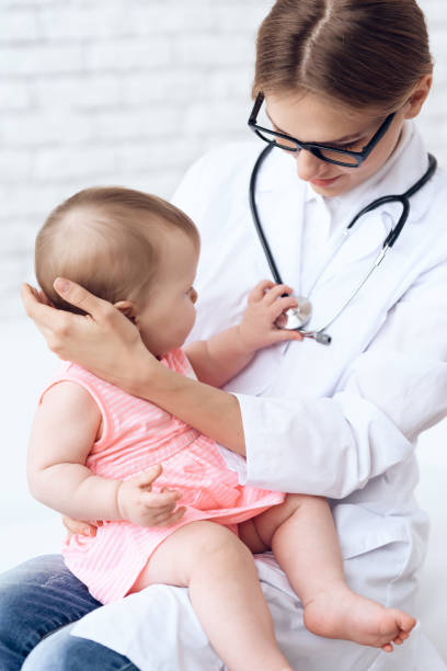istock Pediatrician doctor play with newborn. 984803630