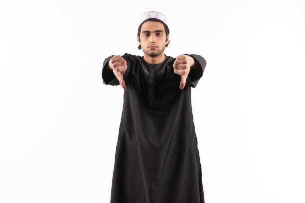 istock Happy Arab man in ethnic clothes shows thumbs down. 984812372
