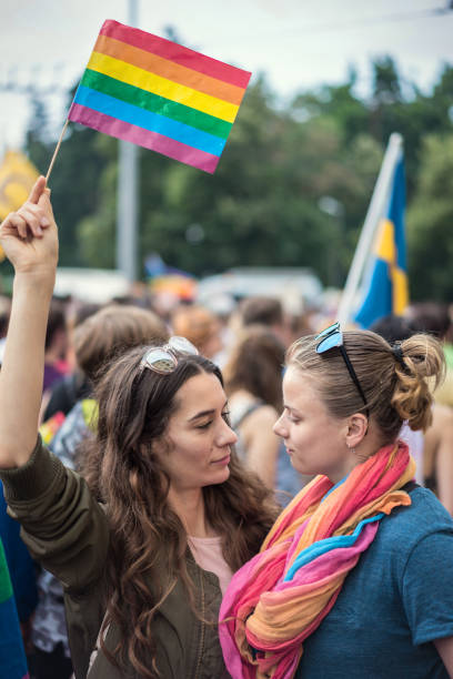 istock Female couple looking at each other at parade 984814114