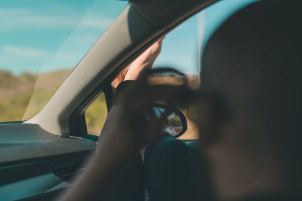 istock Man with his Feet Up in the Car Window 984819452