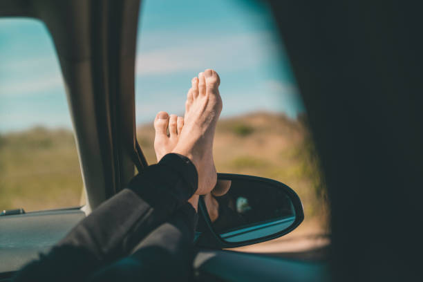 istock Man with his Feet Up in the Car Window 984819454