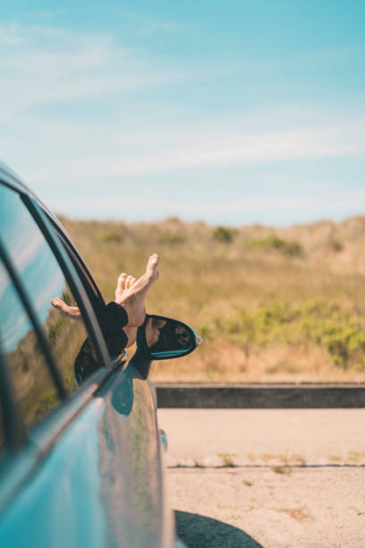 istock Man with his Feet Up in the Car Window 984823338
