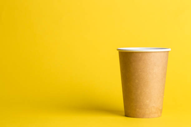 istock coffee to go in a disposable cup on a yellow background 984825020