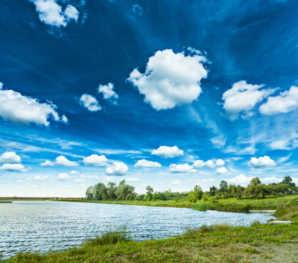 istock lake in spring with beautiful cloudy sky 984837474