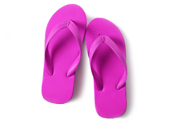 istock Vivid pink flipflops beach sandals isolated on white background 984840312