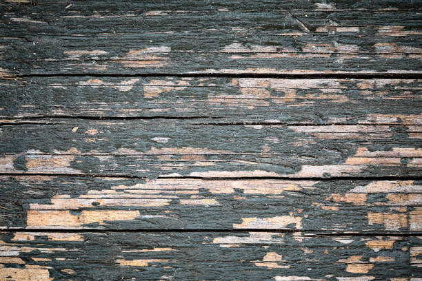 istock Boards horizontal cracks background with dark blue grunged peeling paint over orange pine wood with vignette 984844920