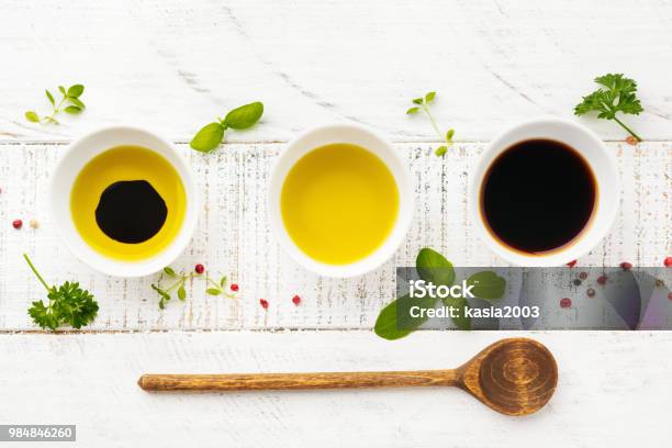 Soy Sauce Olive Oil And Balsamic Sauce With Herbs Basil Parsley Pepper And Thyme On White Wooden Background Top View Stock Photo - Download Image Now