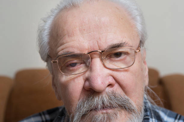 istock Lonely old man with sore eyes 984846382