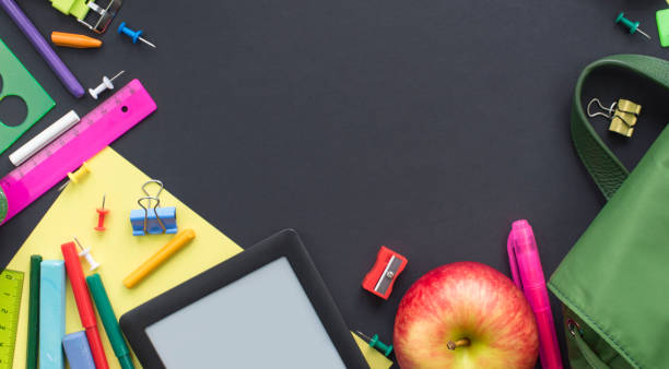 istock Concept back to school apple backpack stationery on black background. 984846448