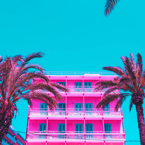 istock pink palm trees and a hotel against the turquoise sky. 984846568
