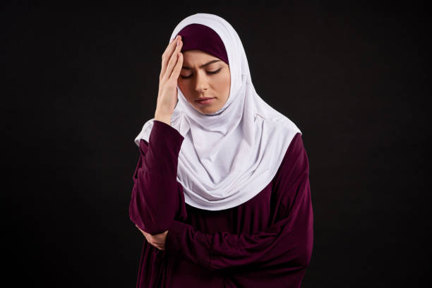 istock Arab young woman in hijab has headache. 984851146