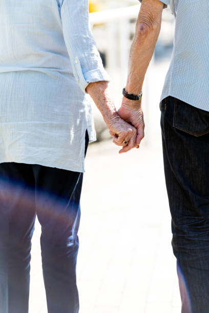 istock Senior couple holding hands. Rear view 984851250