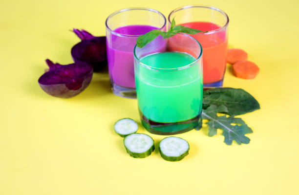 istock Healthy vegetable smoothie and juice on yellow backround 984879034