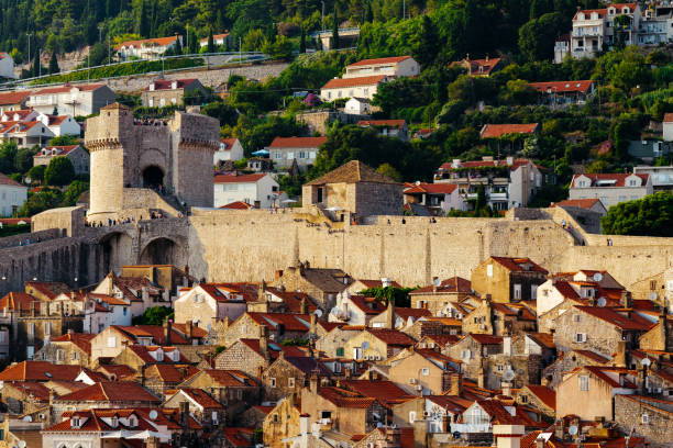 Protective city wall, Minceta tower and houses with red tiles in Dubrovnik, Croatia. Protective city wall, Minceta tower and houses with red tiles in Dubrovnik, Croatia fort minceta dubrovnik stock pictures, royalty-free photos & images