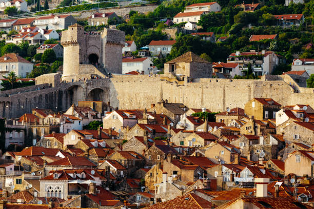 Protective city wall, Minceta tower and houses with red tiles in Dubrovnik, Croatia. Protective city wall, Minceta tower and houses with red tiles in Dubrovnik, Croatia fort minceta dubrovnik stock pictures, royalty-free photos & images
