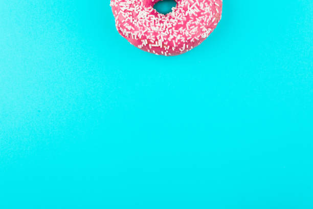 istock one pink isolated donut on a mint background 984904946