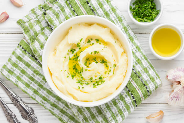 Mashed potatoes with parsley and olive oil in a bowl stock photo